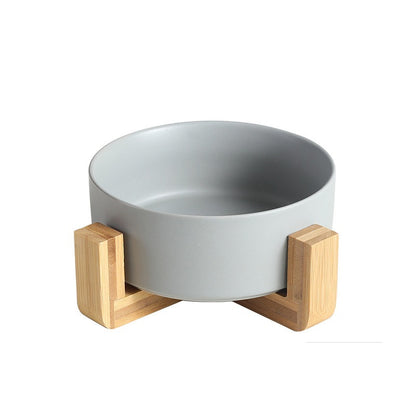 Ceramic food bowl with stable wooden base in a clean design