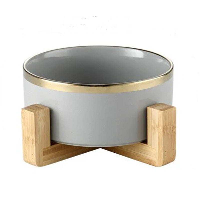 Elegant ceramic food bowl with gold rim and stable wooden base