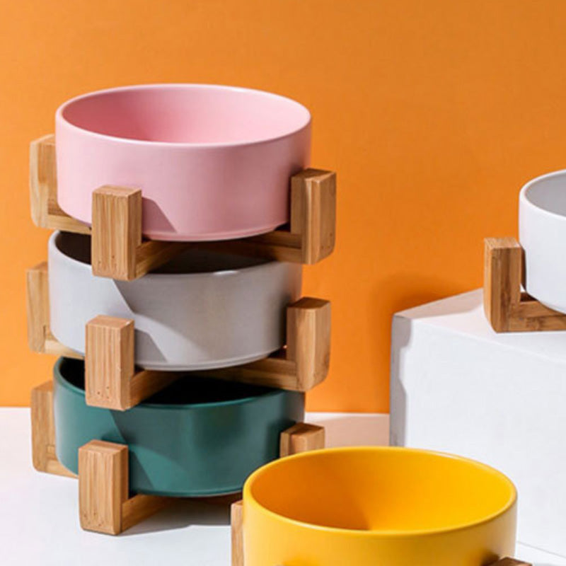 Ceramic food bowl with stable wooden base in a clean design
